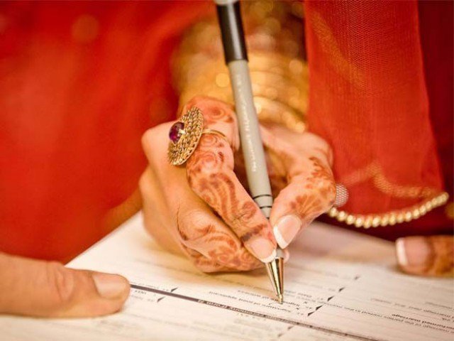 Woman signing a paper