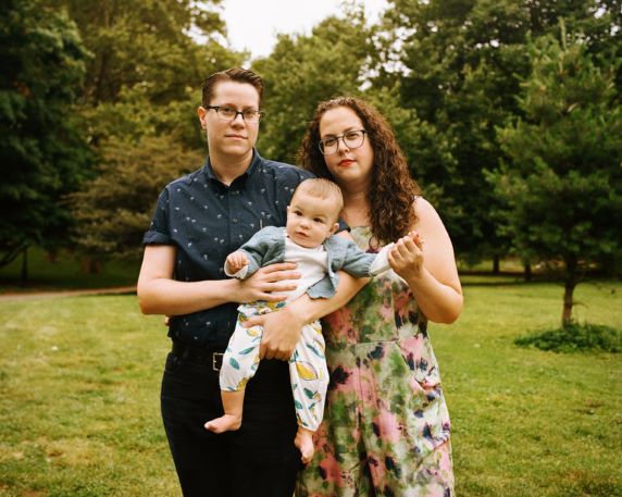 Same sex couple holding a baby