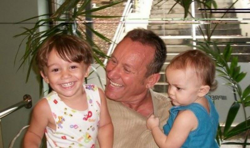 Dad hugging two little girls