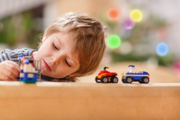Little boy playing toy cars