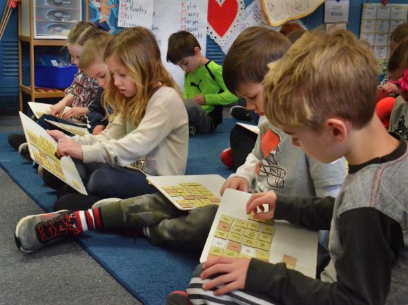 Little kids playing with white boards