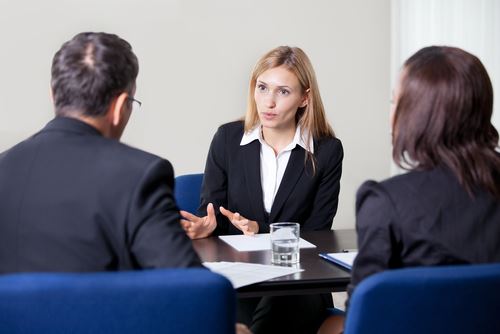 People wearing black suits in a meeting
